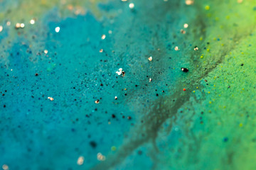 Beautiful colorful background with glitter and colored bubbles in oil and watercolor. Sparkle particles. Macro oil ink bubbles and drops. Abstract template acrylic paint texture. Colored Wallpaper 