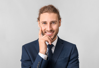 Portrait of businessman on grey background