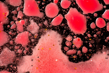 Beautiful colorful background with glitter and colored bubbles in oil and watercolor. Red and black. Macro oil ink bubbles and drops. Abstract template mixed texture. Colored Wallpaper Pattern