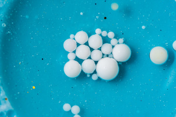 Beautiful colorful background with glitter and colored bubbles in oil and watercolor. Sparkle particles. Macro oil ink bubbles and drops. Abstract template mixed texture. Colored Wallpaper Pattern 