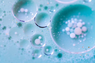 Beautiful colorful background with glitter and colored bubbles in oil and watercolor. Sparkle particles. Macro oil ink bubbles and drops. Abstract template mixed texture. Colored Wallpaper Pattern 