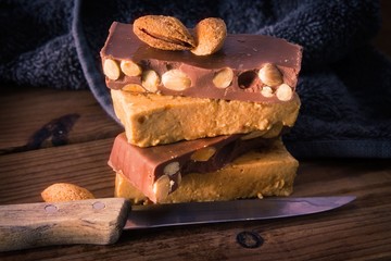 Almond nougat, typical Christmas dessert on wooden background