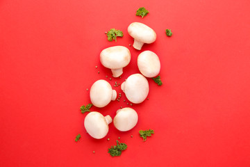 Fresh mushrooms with spices on color background