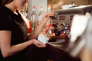 female barista making coffee in coffee shop counter. Barista female working at cafe