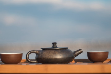 Vintage chinese set with black tea ceremony yixing teapot on green background