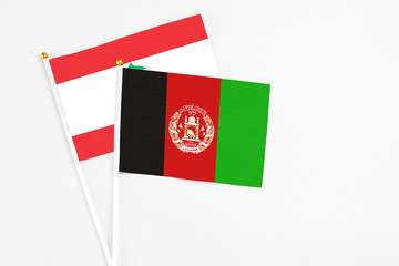 Afghanistan and Lebanon stick flags on white background. High quality fabric, miniature national flag. Peaceful global concept.White floor for copy space.