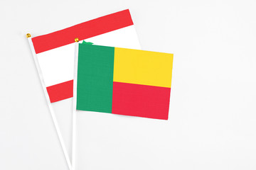 Benin and Lebanon stick flags on white background. High quality fabric, miniature national flag. Peaceful global concept.White floor for copy space.