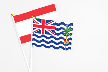 Fototapeta premium British Indian Ocean Territory and Lebanon stick flags on white background. High quality fabric, miniature national flag. Peaceful global concept.White floor for copy space.