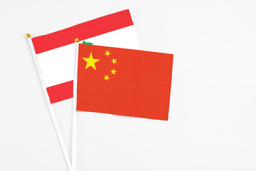 China and Lebanon stick flags on white background. High quality fabric, miniature national flag. Peaceful global concept.White floor for copy space.