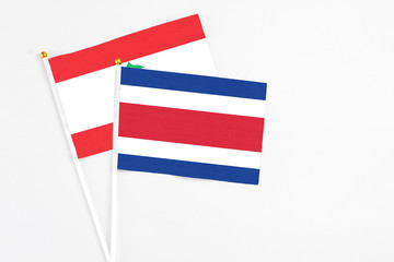 Costa Rica and Lebanon stick flags on white background. High quality fabric, miniature national flag. Peaceful global concept.White floor for copy space.