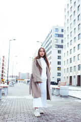 young pretty teenage girl posing cheerful happy smiling wearing street style outside in europe city, lifestyle people concept