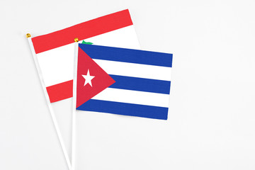 Cuba and Lebanon stick flags on white background. High quality fabric, miniature national flag. Peaceful global concept.White floor for copy space.