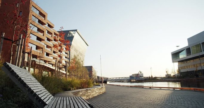 4K low angle wide shot with forward slide motion of Lambda, the new Edvard Munch museum, with famous paintings like The Jealousy, in a late autumn sunset in the Bj&oslash;rvika quarter in Oslo, Norway.