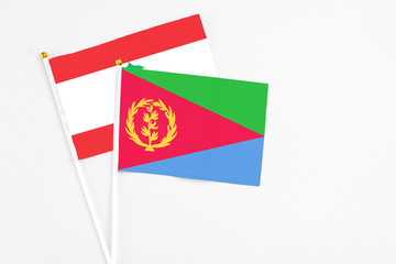 Eritrea and Lebanon stick flags on white background. High quality fabric, miniature national flag. Peaceful global concept.White floor for copy space.