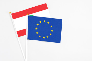 European Union and Lebanon stick flags on white background. High quality fabric, miniature national flag. Peaceful global concept.White floor for copy space.