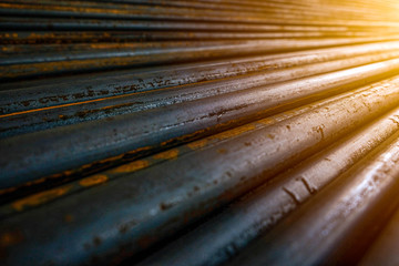 Long hollow inside bars of steel, stack in layers to wait for the construction of residential buildings or many utility systems in the morning. Taken at the storage area, construction site, Thailand