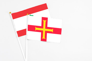 Guernsey and Lebanon stick flags on white background. High quality fabric, miniature national flag....