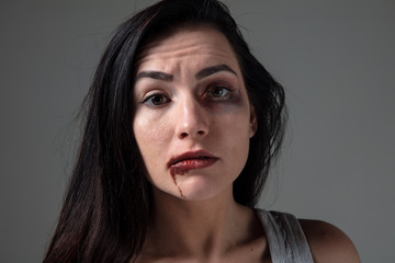 Woman in fear of domestic abuse and violence, concept of female rights. Caucasian brunette woman on...