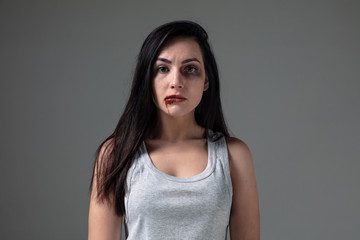 Woman in fear of domestic abuse and violence, concept of female rights. Caucasian brunette woman on...