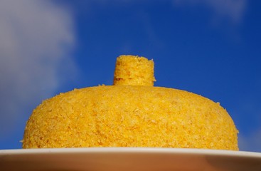 Brazilian couscous. Traditional Brazilian breakfast with sky as background.