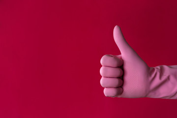 Pink left hand thumb-up gesture on red