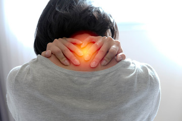 Asian women used 2 hands press the back of the neck, signs of fatigue and pain maybe caused by sports, hard work or from the office syndrome. She's want to go hospital, meet doctor for first aid asap.