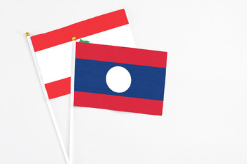 Laos and Lebanon stick flags on white background. High quality fabric, miniature national flag. Peaceful global concept.White floor for copy space.