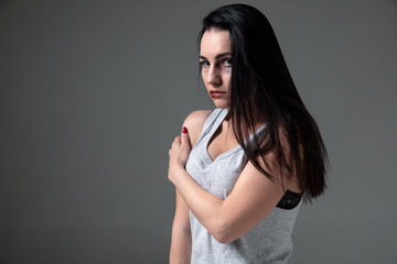 Woman in fear of domestic abuse and violence, concept of female rights. Caucasian brunette woman on...