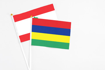 Mauritius and Lebanon stick flags on white background. High quality fabric, miniature national flag. Peaceful global concept.White floor for copy space.