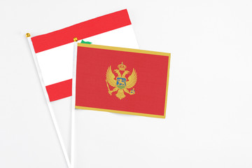 Montenegro and Lebanon stick flags on white background. High quality fabric, miniature national...