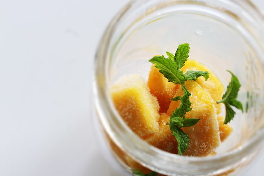Frozen mango and mint in bottle for jar drink image
