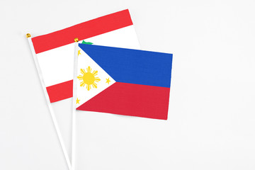 Philippines and Lebanon stick flags on white background. High quality fabric, miniature national flag. Peaceful global concept.White floor for copy space.