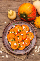 Roasted pumpkin with salted cheese and herbs