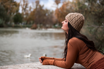 sad woman looking towards a lake