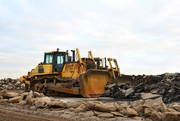 Track-type bulldozer, earth-moving equipment. Land clearing, grading, pool excavation, utility trenching, utility trenching and foundation digging during of large construction jobs. Crawler Dozers