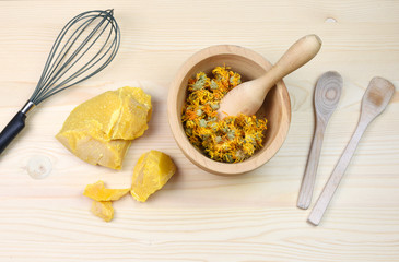 Medical herbs concept with dry cannabis, verbascum and calendula on a wooden background. Production of homemade ointment.