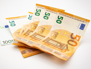 Fifty Euro money is stacked against a light background.