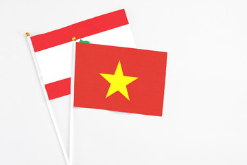 Vietnam and Lebanon stick flags on white background. High quality fabric, miniature national flag. Peaceful global concept.White floor for copy space.