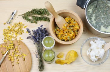 Medical herbs concept with dry cannabis, verbascum and calendula on a wooden background. Production...