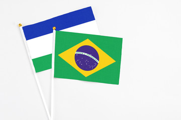 Brazil and Lesotho stick flags on white background. High quality fabric, miniature national flag....