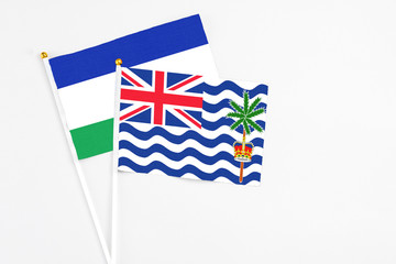British Indian Ocean Territory and Lesotho stick flags on white background. High quality fabric,...