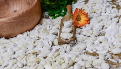 Homemade gnocchi, prepared on the table with ingredients.