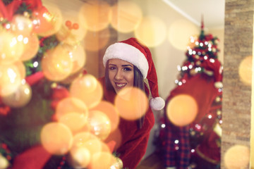 Fototapeta na wymiar Girl and decorating beautiful christmas tree