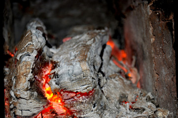 Glowing red embers. burning logs. heating firewood in oven