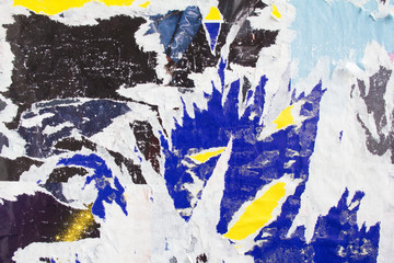 Ripped and peeling paper posters on dirty billboard texture background.