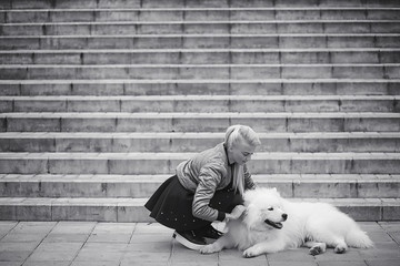 Lovely girl on a walk with a beautiful dog