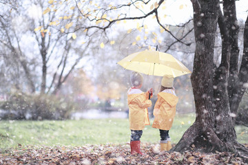 Kids walk in the park first snow