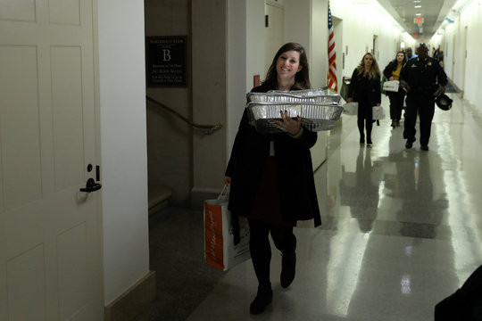 People carry catered food and boxes of coffee in the hallways ahead of testimony by former U.S. ambassador to Ukraine Yovanovitch before a House Intelligence Committee hearing as part of the Trump impeachment inquiry on Capitol Hill in Washington