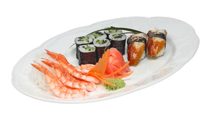 Sushi with eel and rolls with cucumber and nori. Shrimps, rice noodle, ginger and wasabi on white oval plate