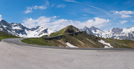 Large wide panorama of mountain pass Fuscher Torl, view point on Grossglockner High Alpine Road, Austria. Sunny summer day, snowy peaks, top mountains